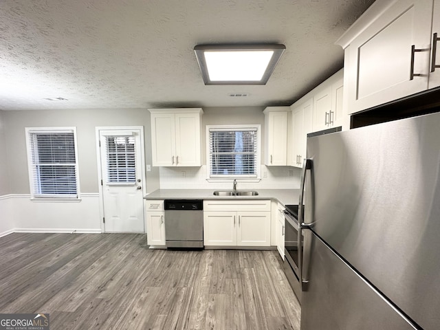 kitchen with white cabinets, stainless steel appliances, and sink