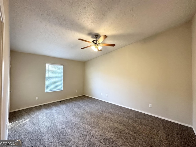 spare room featuring ceiling fan, carpet floors, and a textured ceiling