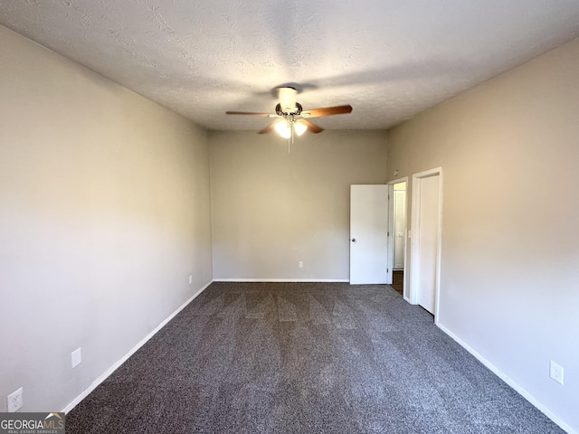 carpeted empty room with ceiling fan and a textured ceiling