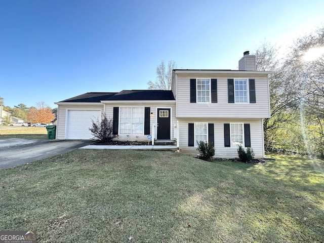 tri-level home featuring a front yard and a garage