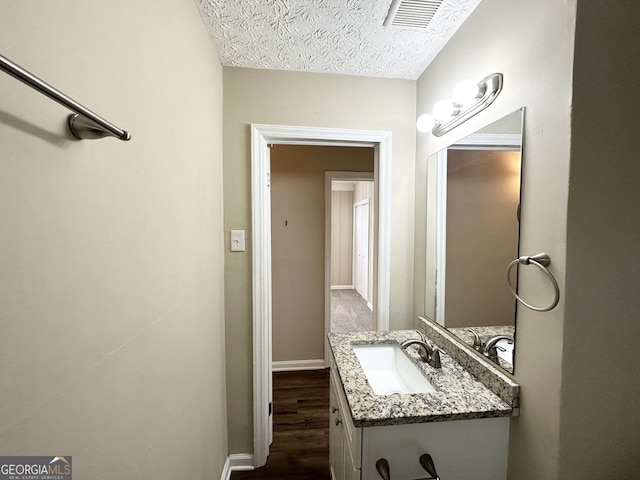 bathroom with vanity and wood-type flooring