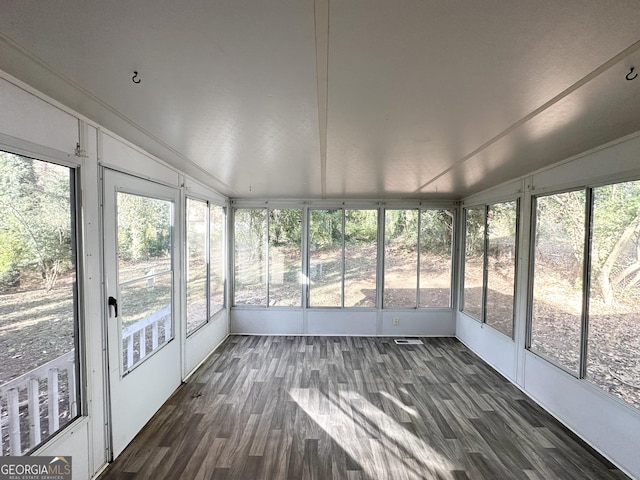 unfurnished sunroom featuring lofted ceiling and a wealth of natural light