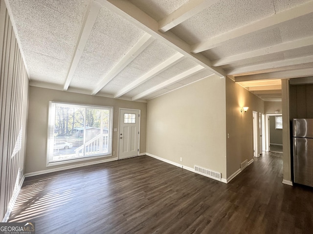 interior space with vaulted ceiling with beams and dark wood-type flooring