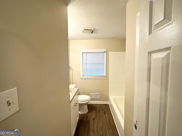 full bathroom with hardwood / wood-style floors, vanity, toilet, and independent shower and bath