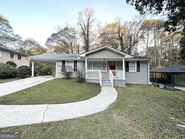 view of front of property with a carport, a porch, and a front lawn