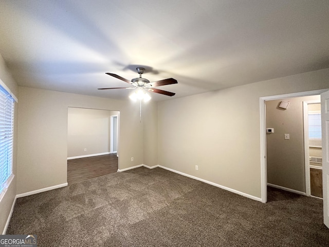 carpeted empty room featuring ceiling fan