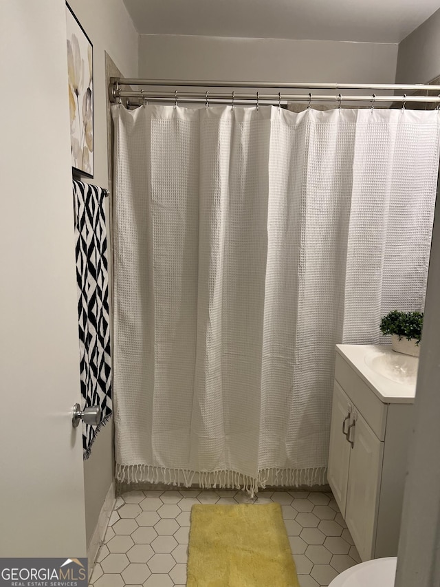 bathroom featuring tile patterned floors, vanity, and a shower with shower curtain