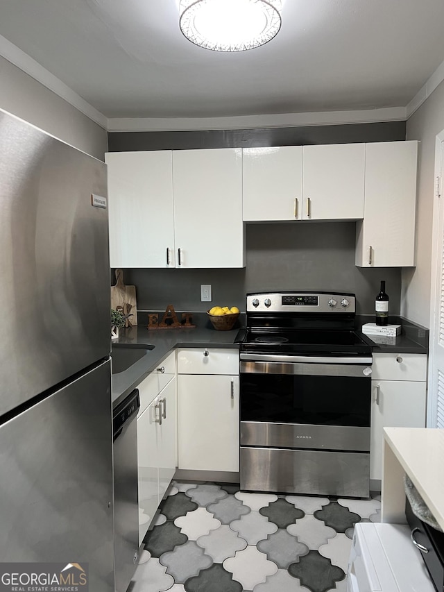 kitchen featuring sink, crown molding, white cabinets, and appliances with stainless steel finishes