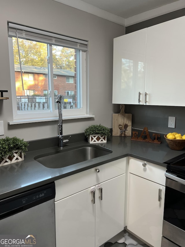 kitchen featuring sink, ornamental molding, white cabinets, and appliances with stainless steel finishes