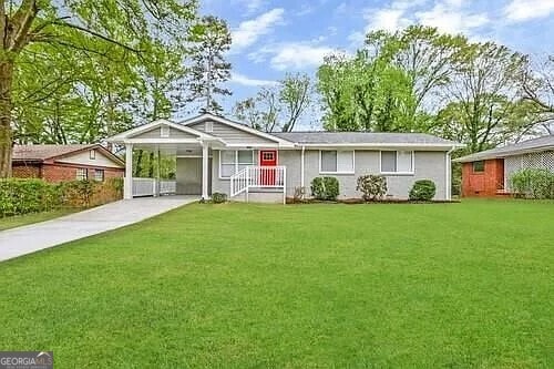 ranch-style home with a carport and a front yard