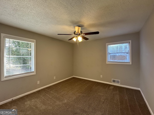 carpeted spare room featuring a textured ceiling and ceiling fan