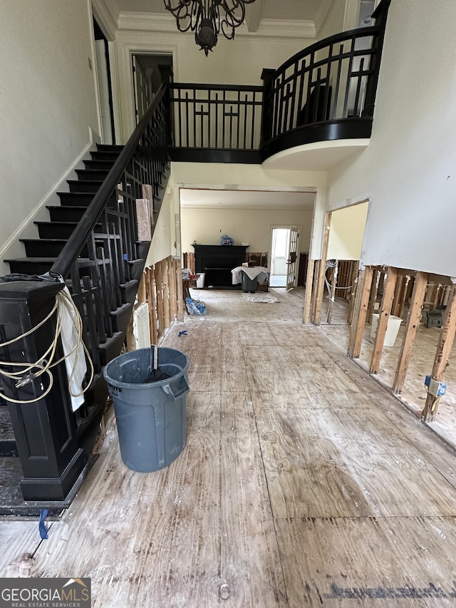 staircase featuring wood-type flooring and an inviting chandelier