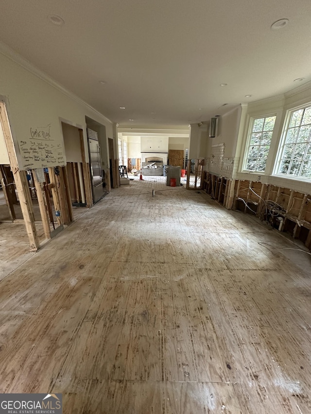 miscellaneous room featuring hardwood / wood-style flooring and crown molding