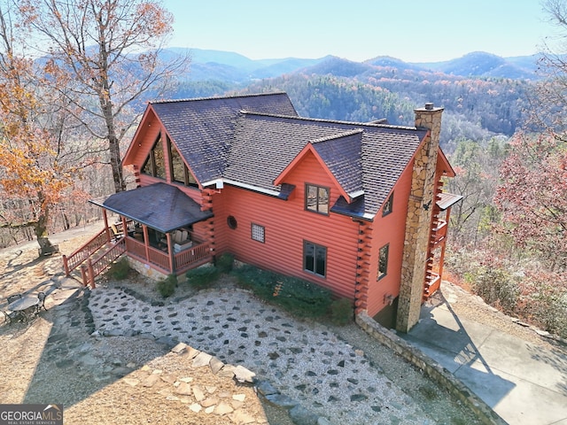 exterior space with a mountain view and covered porch