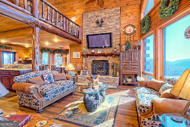 living room featuring wood walls, high vaulted ceiling, wood ceiling, and wood-type flooring