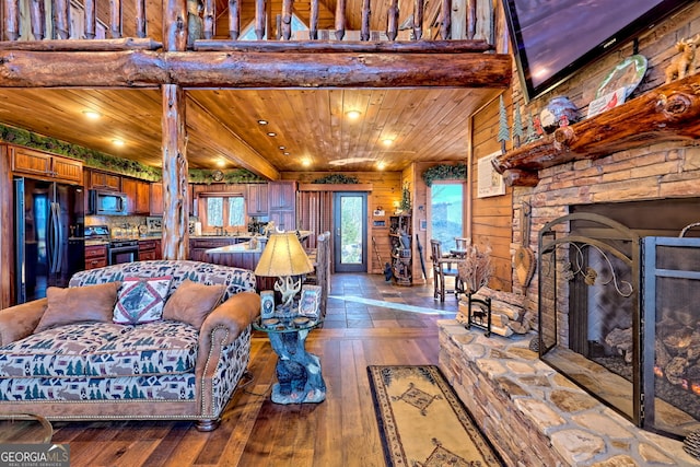 living room featuring wood walls, a stone fireplace, wood-type flooring, and wood ceiling