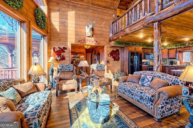 living room featuring wood walls, dark hardwood / wood-style flooring, and wooden ceiling