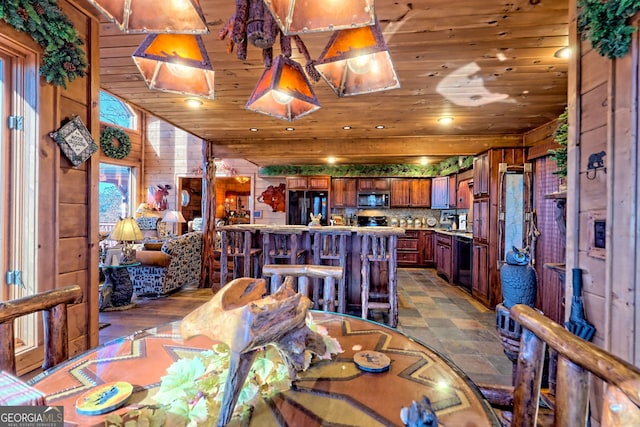 dining room featuring wood walls and wooden ceiling