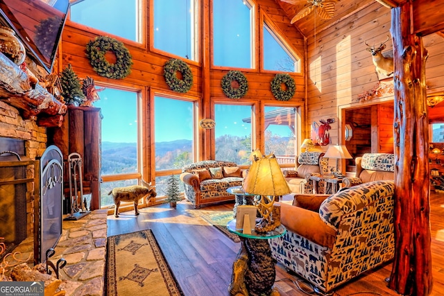 living room with a mountain view, plenty of natural light, and wood-type flooring