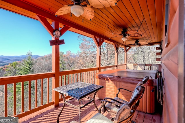 deck featuring a hot tub and ceiling fan