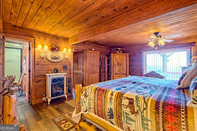 bedroom featuring wooden ceiling, a wood stove, wooden walls, dark hardwood / wood-style floors, and ceiling fan