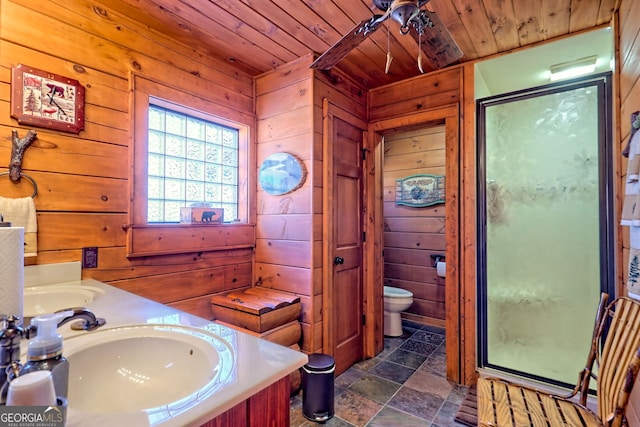 bathroom featuring vanity, wooden ceiling, toilet, a shower with shower door, and wood walls