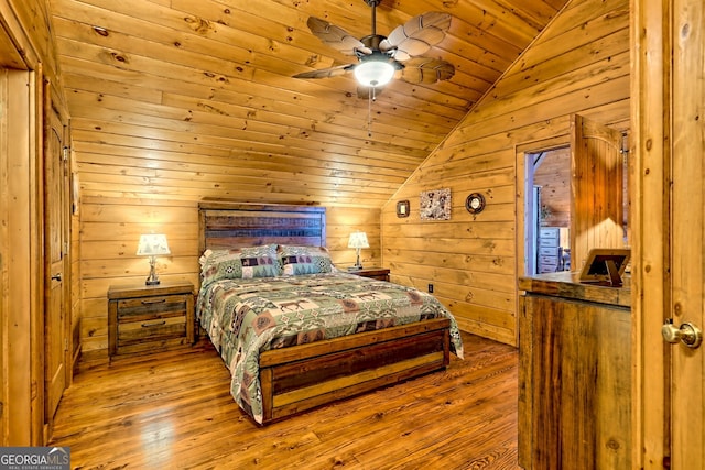 bedroom with light wood-type flooring, ceiling fan, wooden ceiling, lofted ceiling, and wood walls