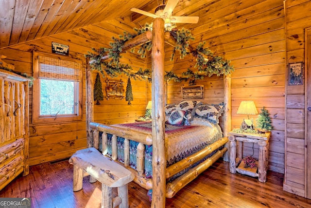 bedroom featuring hardwood / wood-style flooring, wood walls, lofted ceiling, and wood ceiling