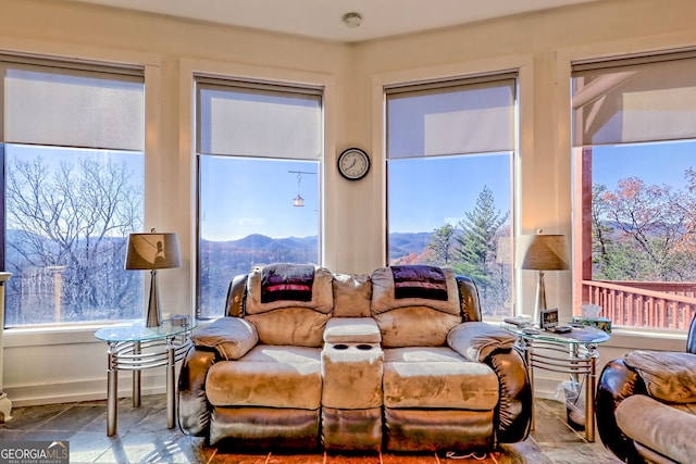 living room featuring a mountain view and a healthy amount of sunlight