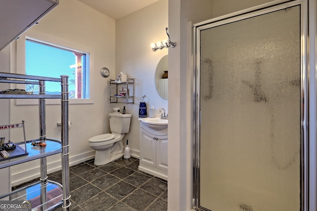 bathroom featuring vanity, an enclosed shower, and toilet