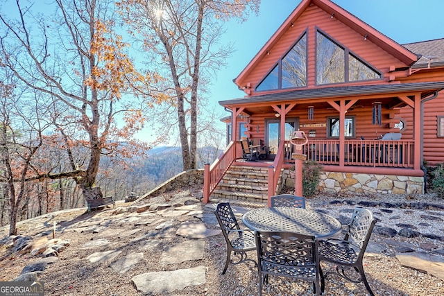 exterior space with a mountain view, a patio area, and covered porch