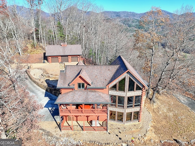 back of property featuring a deck with mountain view