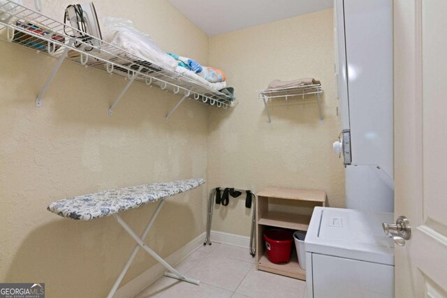 interior space featuring light tile patterned flooring and washer / dryer