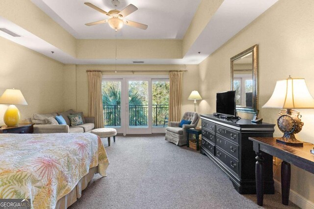 bedroom featuring a raised ceiling, ceiling fan, access to exterior, and carpet floors