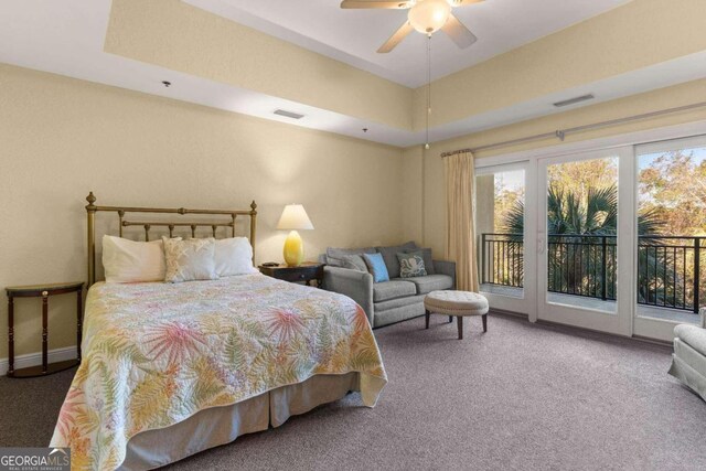 bedroom with carpet flooring, ceiling fan, a raised ceiling, and access to outside