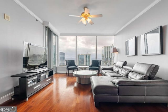 living room featuring hardwood / wood-style flooring, ceiling fan, and ornamental molding