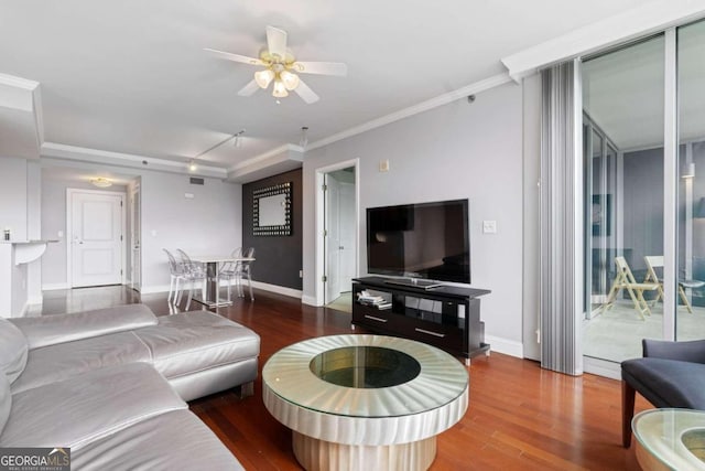 living room with crown molding, ceiling fan, wood-type flooring, and rail lighting