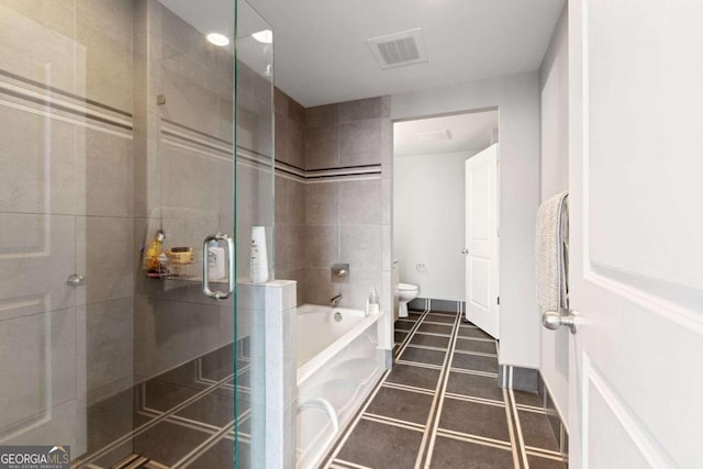 bathroom featuring shower with separate bathtub and toilet