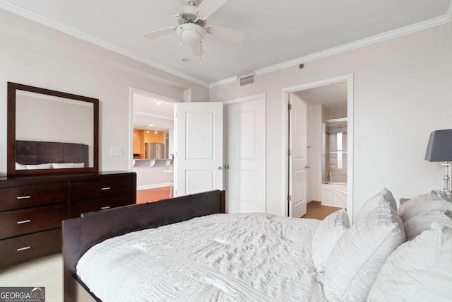 bedroom featuring ensuite bathroom, ceiling fan, ornamental molding, and light hardwood / wood-style flooring