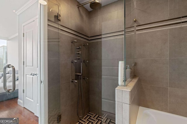 bathroom featuring hardwood / wood-style flooring and separate shower and tub