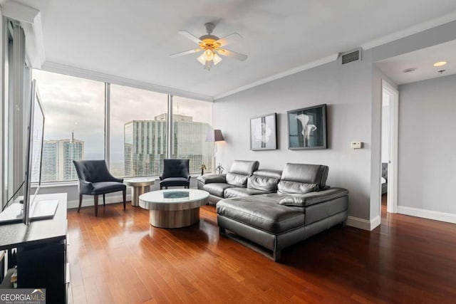 living room with hardwood / wood-style floors, ceiling fan, and ornamental molding