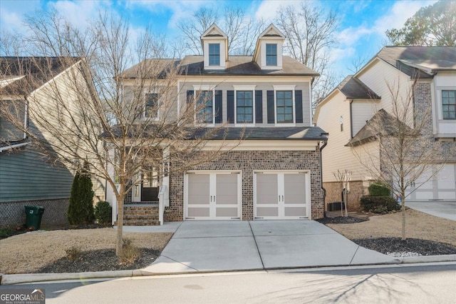 view of front of home featuring central AC and a garage