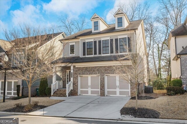 view of front of house featuring a front yard, a garage, and cooling unit