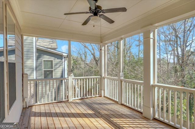 unfurnished sunroom featuring ceiling fan