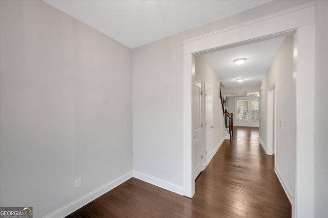 corridor with dark wood-type flooring