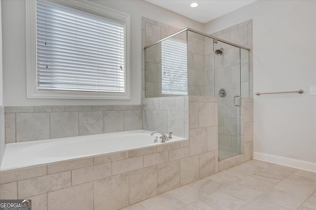 bathroom featuring independent shower and bath