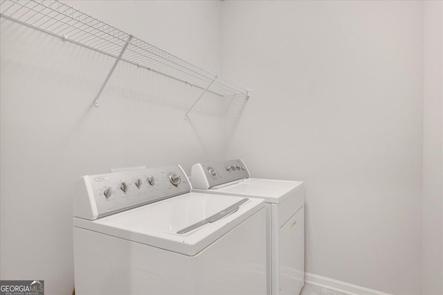 clothes washing area with separate washer and dryer