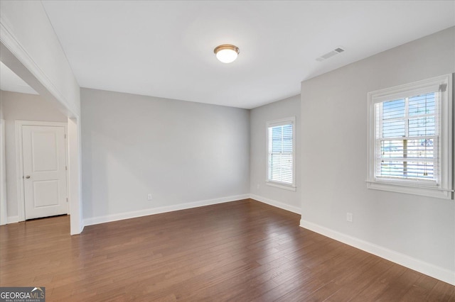 spare room with dark hardwood / wood-style flooring