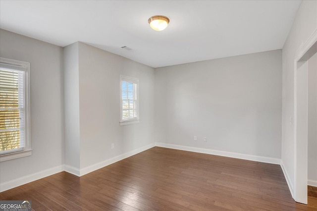 unfurnished room featuring hardwood / wood-style flooring