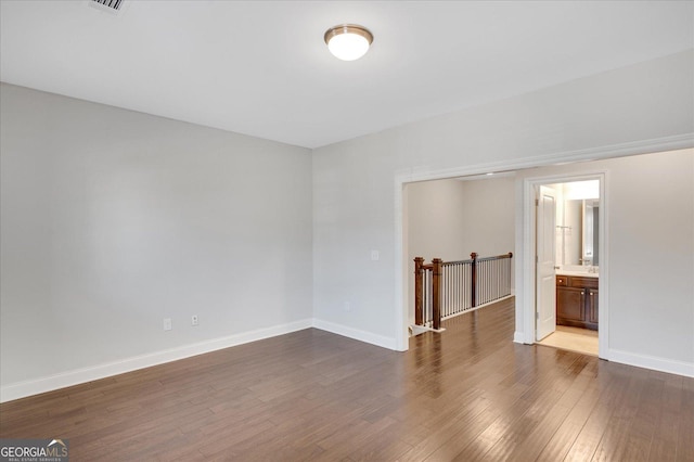 spare room featuring dark hardwood / wood-style flooring